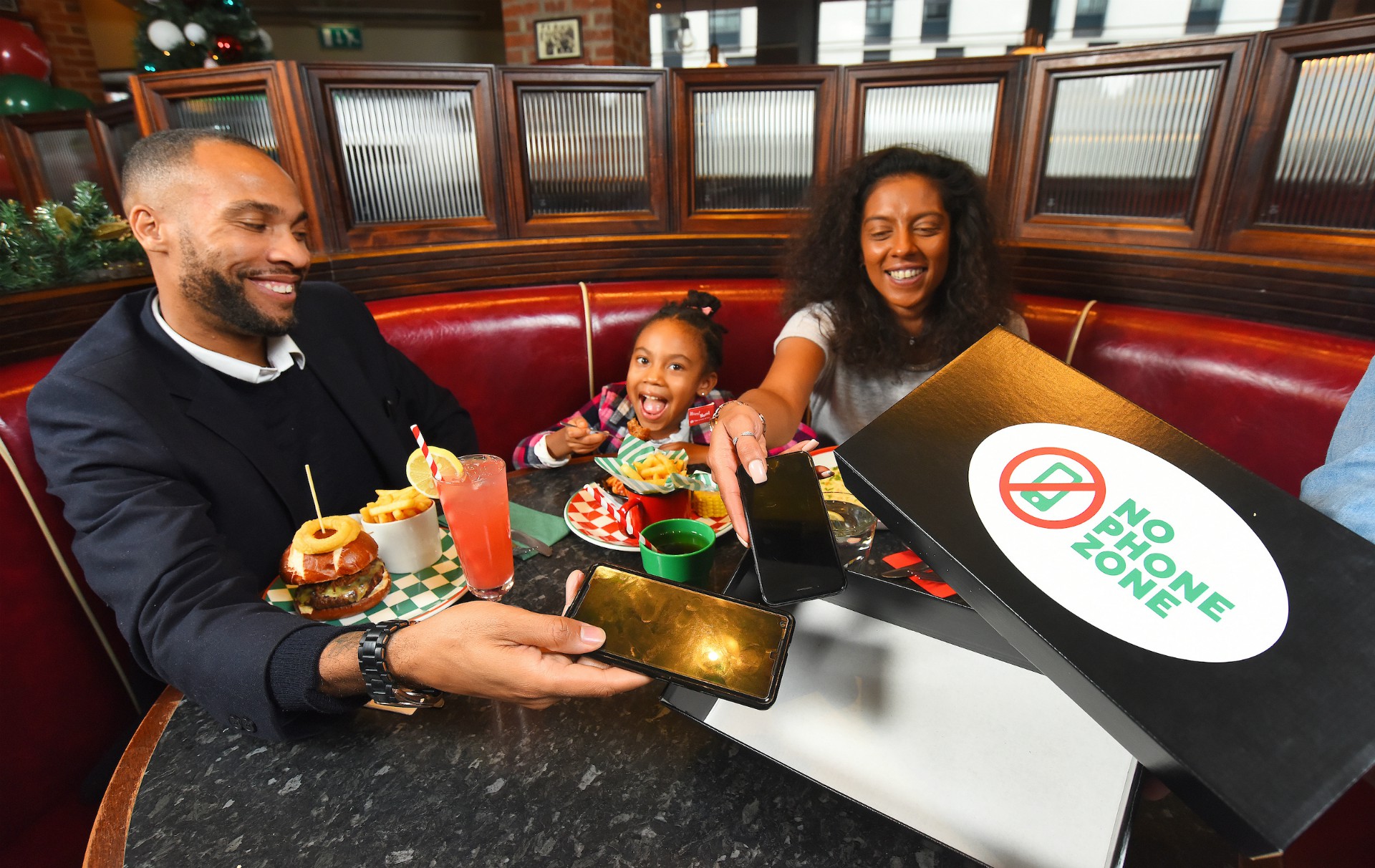 Family Enjoying Their Food at a Restaurant in a Booth